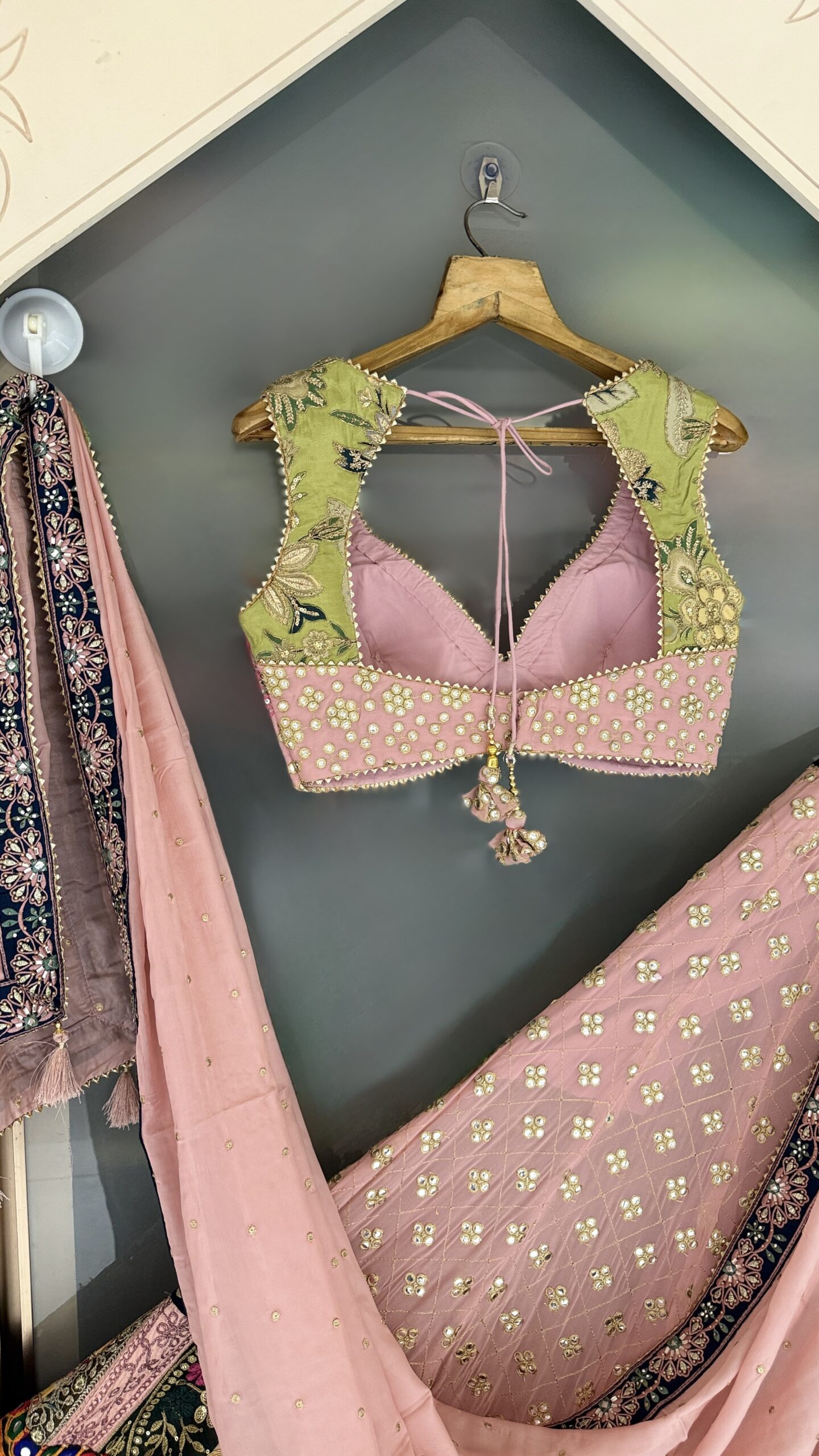 Blush pink designer lehenga with embroidered blouse and multicolor heritage border