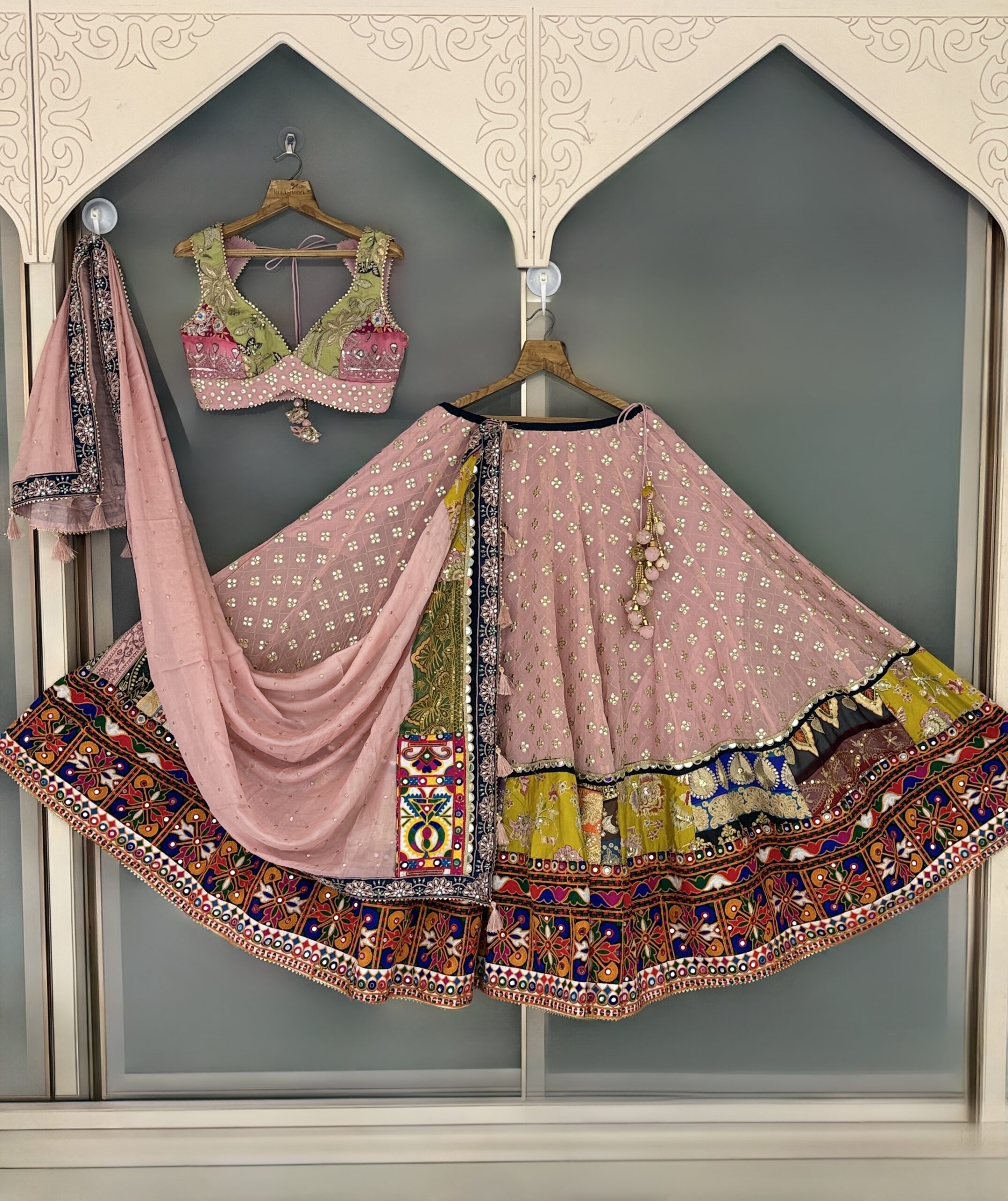 Blush pink designer lehenga with embroidered blouse and multicolor heritage border